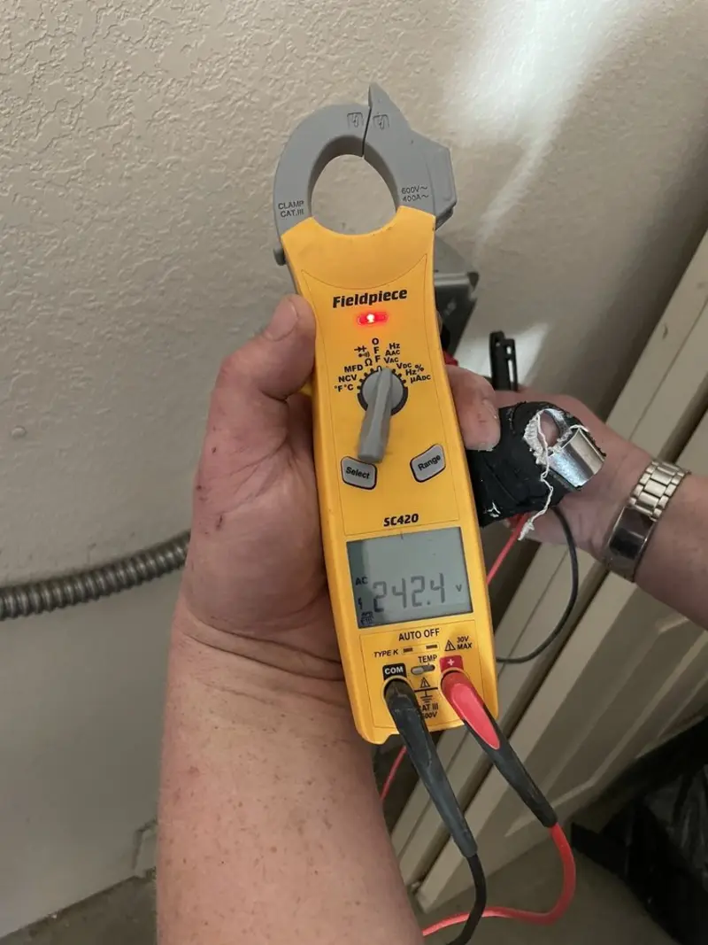 Voltage testing with clamp meter during Electrical Installation Services in Camden